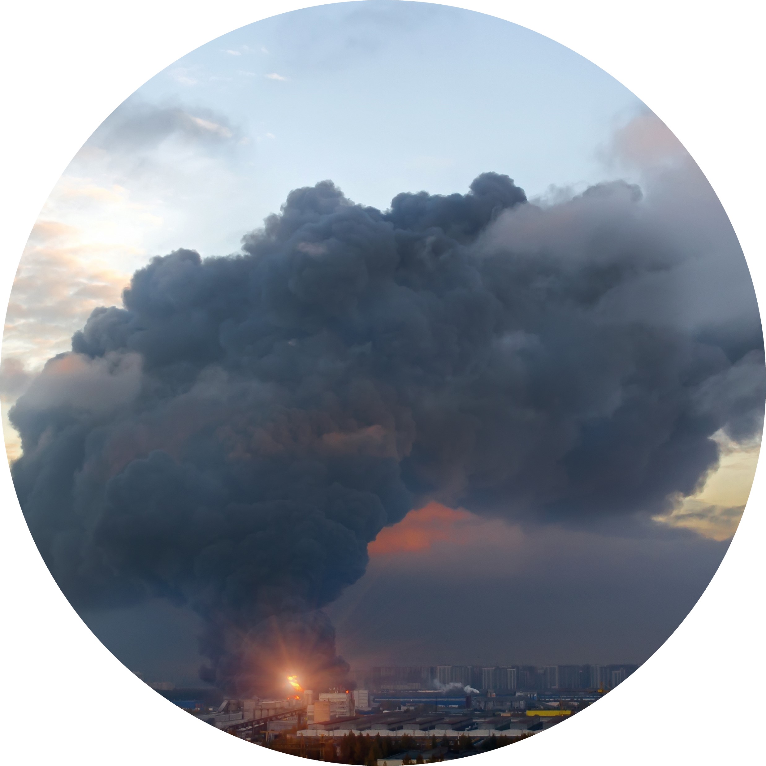 large black cloud of smoke coming from a fire at a facility