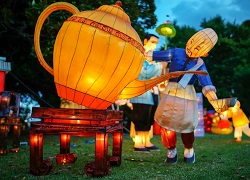 A Chinese lantern in the shape of a man pouring a large teapot