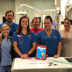 Veterinary staff pose in their practice with a tablet running ezyVet's cloud-based software. The Auckland-based company is hoping to become the Xero of the veterinary world, with a platform that streamlines veterinary practice and hospital management.