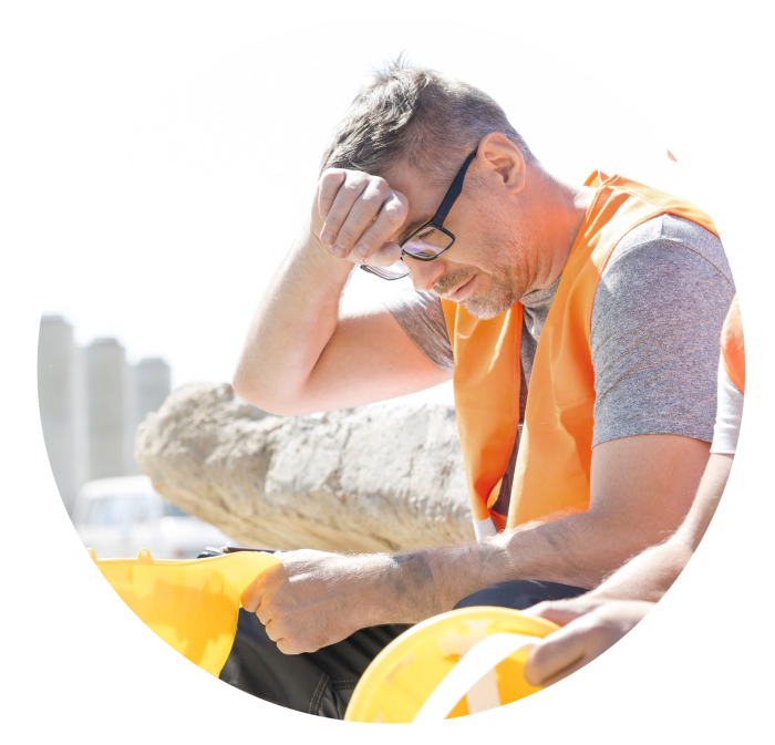 Photo cropped into a circle of a worker sitting in the sun