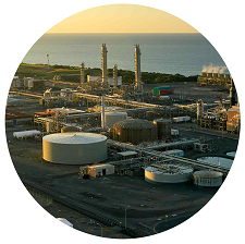 Photo cropped into a circle of an oil refinery 