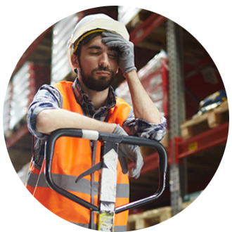 Photo cropped into a circle of a worker in a warehouse looking tired